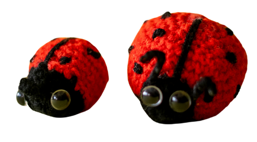 A pair of handmade crochet ladybugs